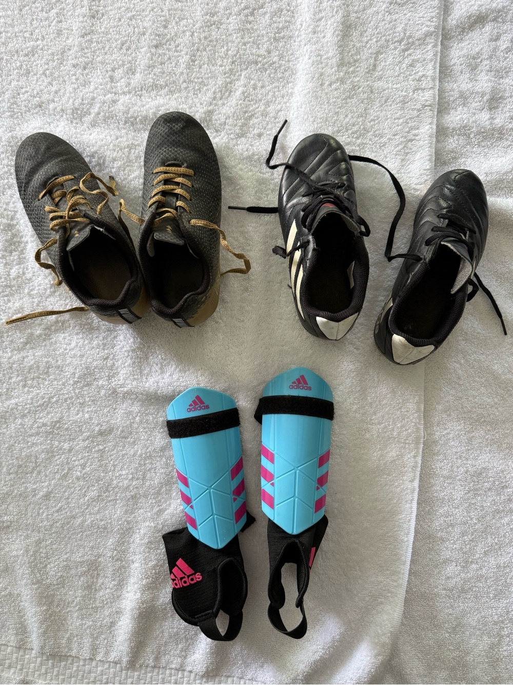 Bundle of 2 pair soccer shoes and 1  pair of shin guards. Boys shoes size 1 & 2.